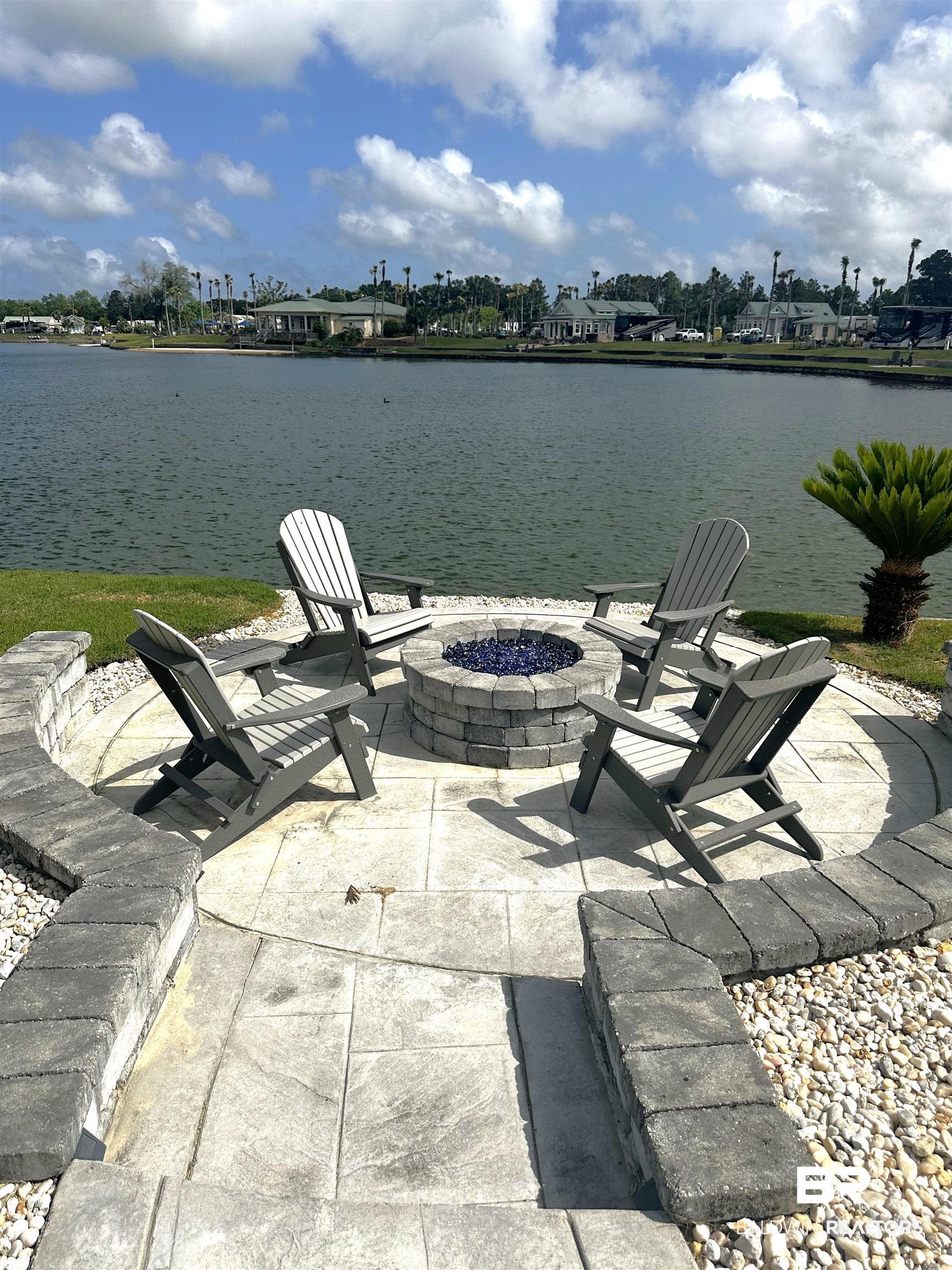 28058 Migratory Way, Unit 100 Elberta, AL 36530 - Photo 22 of 83 Exterior space featuring a water view and an outdoor fire pit