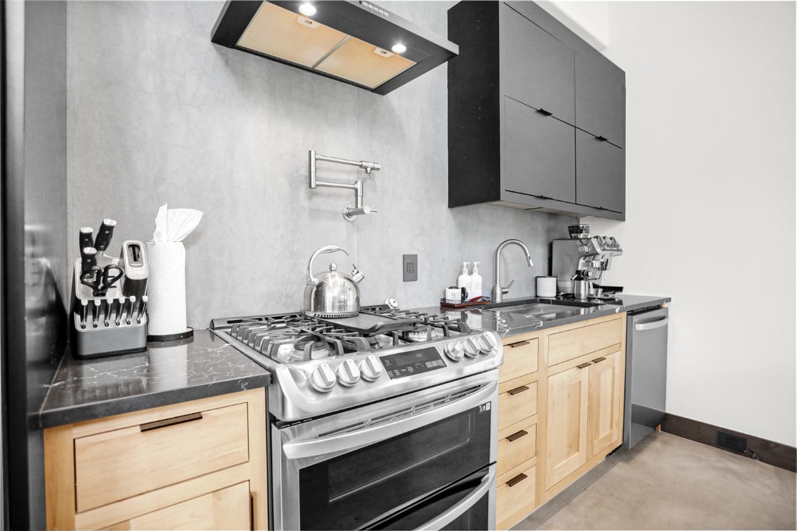150 Game Trail Road Silverthorne, CO 80498 - Photo 13 of 47 a kitchen with stainless steel appliances granite countertop a stove a sink and a microwave