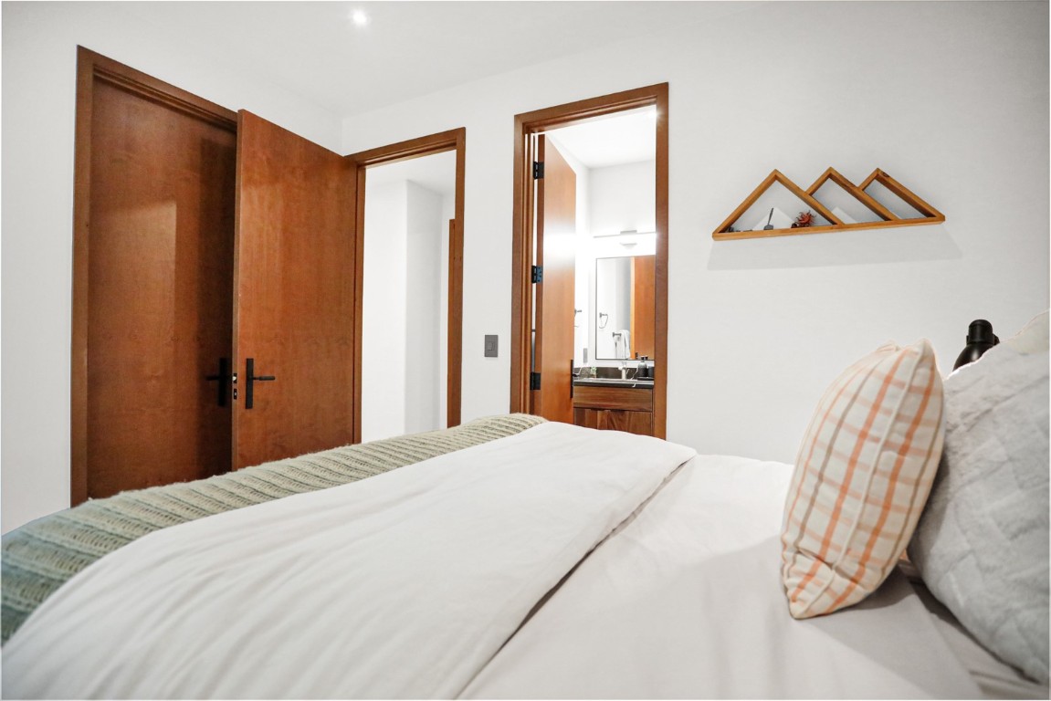 150 Game Trail Road Silverthorne, CO 80498 - Photo 27 of 47 a bedroom with a bed and a painting on the wall