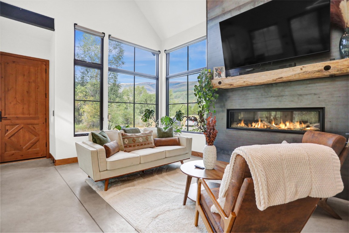 150 Game Trail Road Silverthorne, CO 80498 - Photo 7 of 47 a living room with furniture a fireplace and a flat screen tv