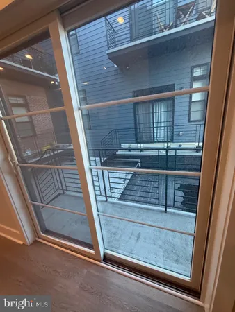 a view of a kitchen with refrigerator and window