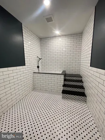 a bathroom with a black white checkered floor