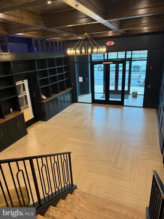a view of a room with wooden floor and windows