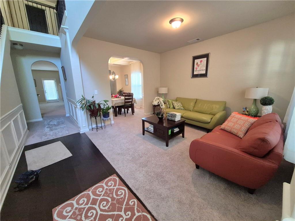 2269 Reddy Farm Lane Grayson, GA 30017 - Photo 11 of 46 a living room with furniture and a chandelier