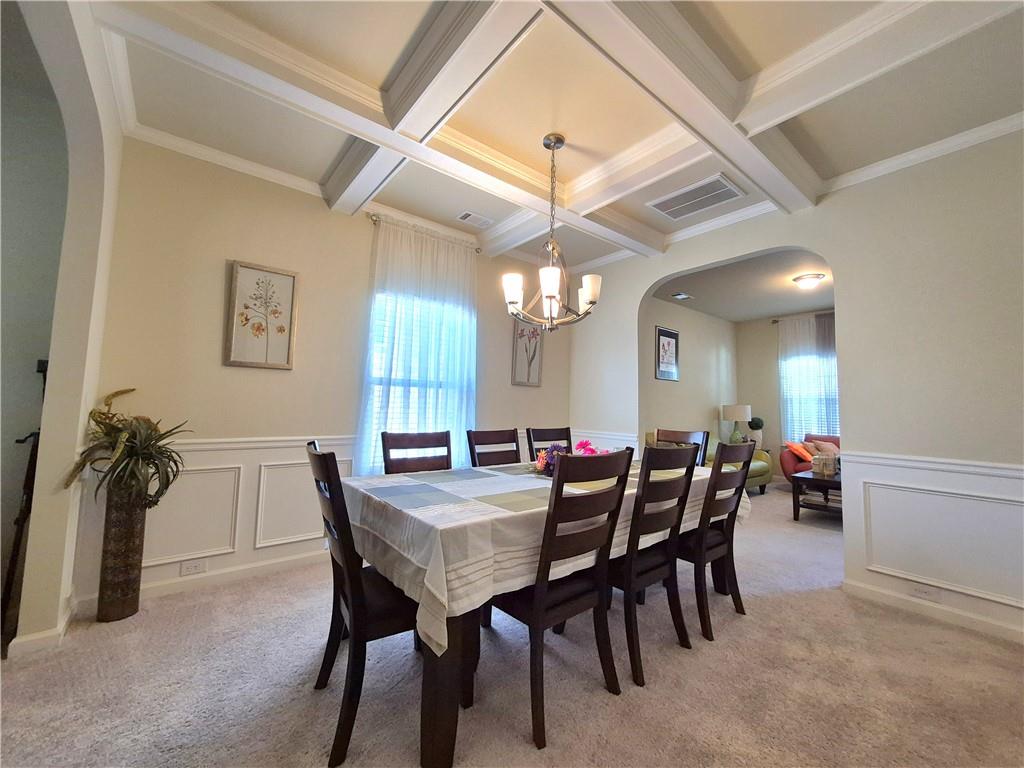2269 Reddy Farm Lane Grayson, GA 30017 - Photo 14 of 46 a view of a dining room with furniture and chandelier