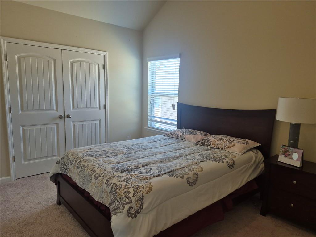 2269 Reddy Farm Lane Grayson, GA 30017 - Photo 31 of 46 a bedroom with a bed and a lamp
