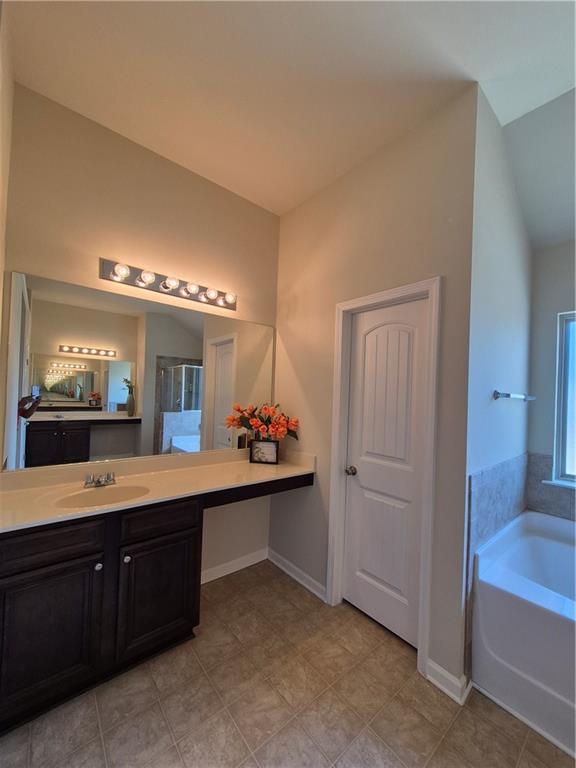 2269 Reddy Farm Lane Grayson, GA 30017 - Photo 38 of 46 a spacious bathroom with a double vanity sink and a mirror