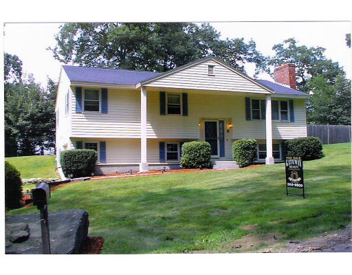 9 Bashaw Road Sutton, MA 01590 - Photo 1 of 1 a front view of a house with a yard