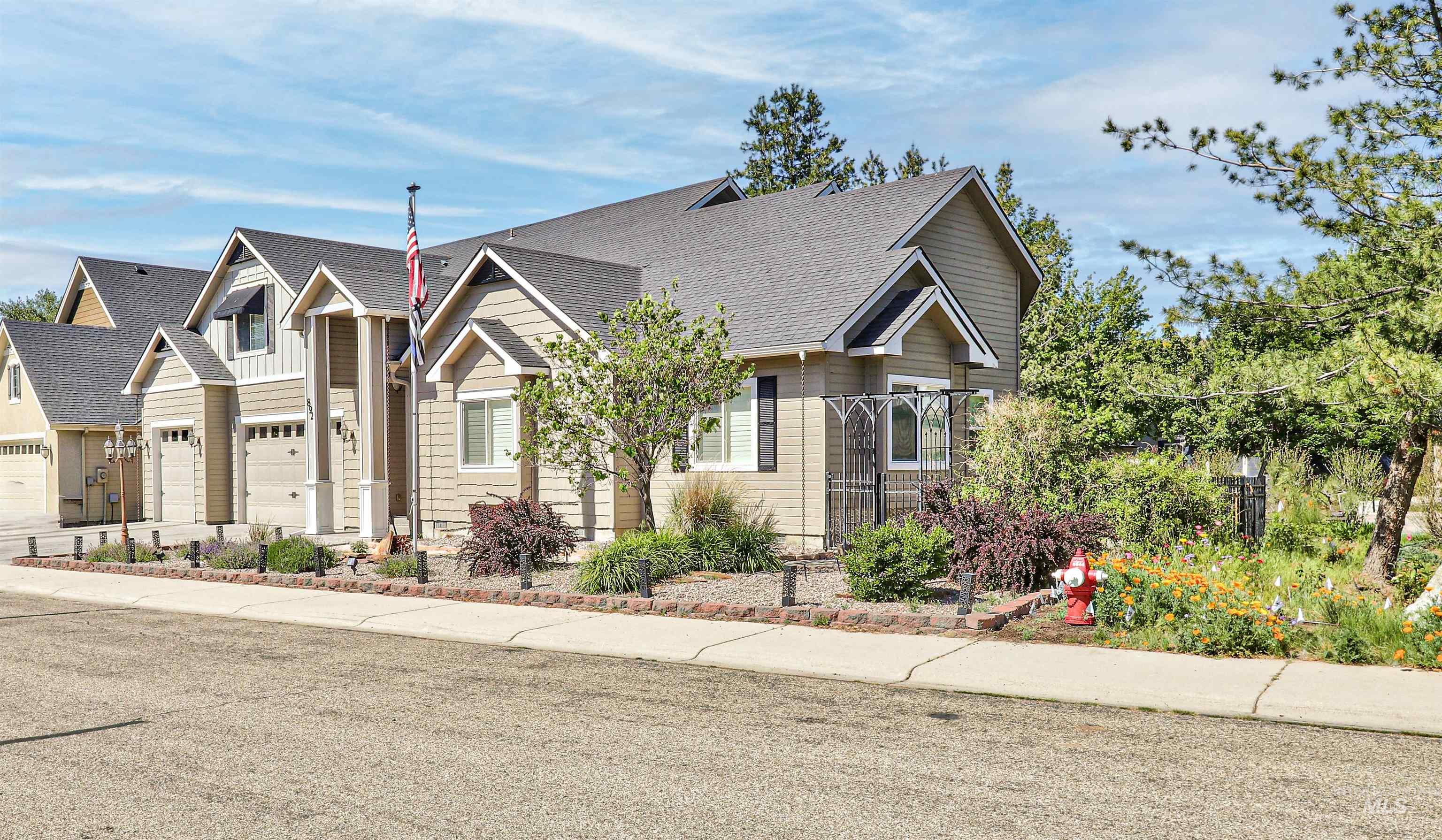 892 South Capitola Way Boise, ID 83712 - Photo 2 of 34 Exterior property featuring gabled rooflines, neutral-toned siding, and multiple garage doors