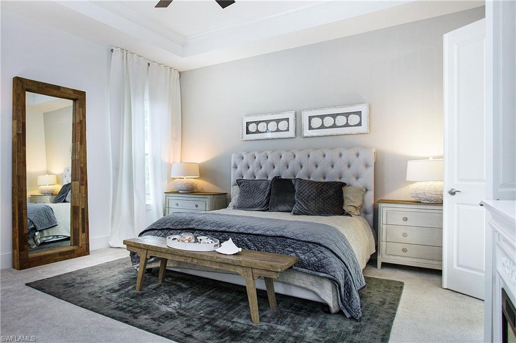 14856 Dockside Lane Naples, FL 34114 - Photo 21 of 50 a bedroom with a bed and a table in it