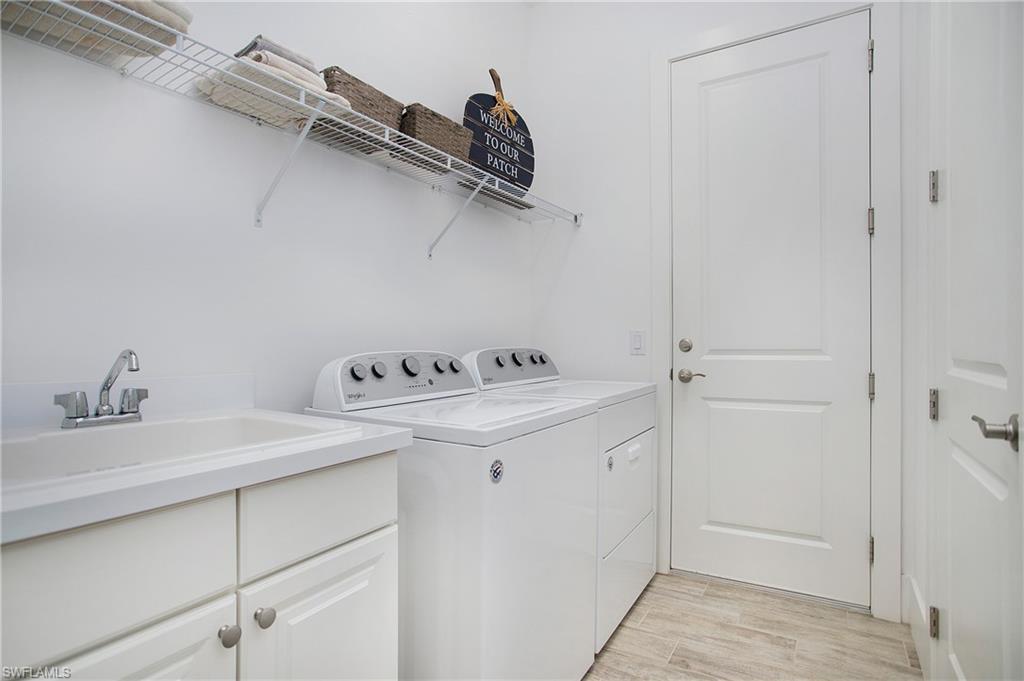 14856 Dockside Lane Naples, FL 34114 - Photo 37 of 50 a bathroom with a sink and a mirror