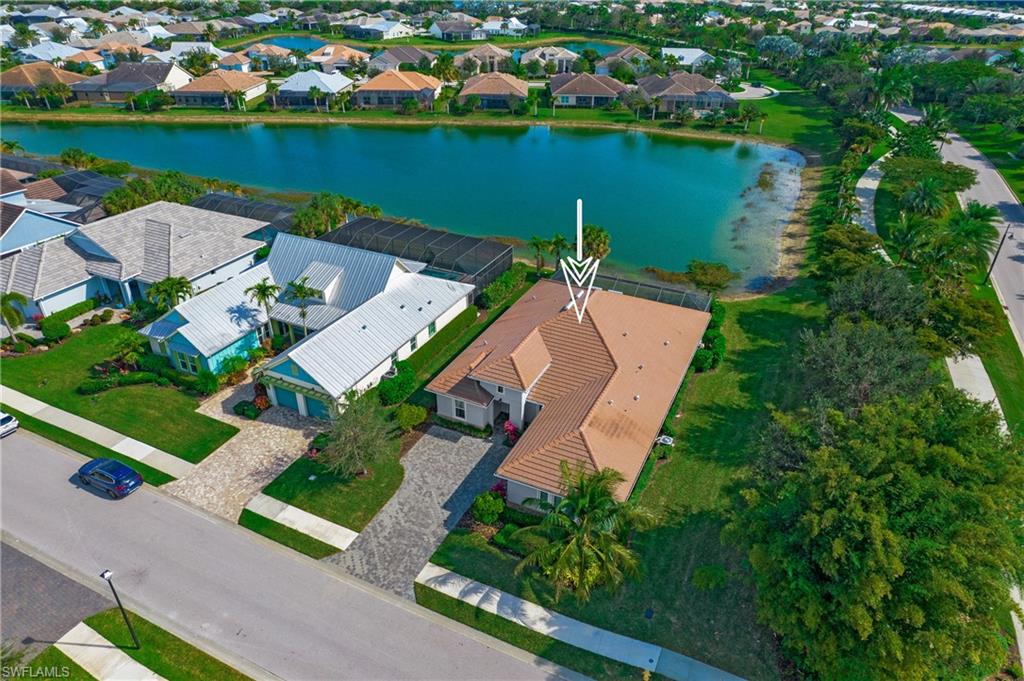 14856 Dockside Lane Naples, FL 34114 - Photo 4 of 50 an aerial view of a house with a lake view