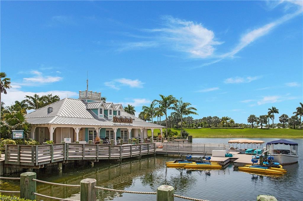 14856 Dockside Lane Naples, FL 34114 - Photo 46 of 50 a view of a lake with a building in the background