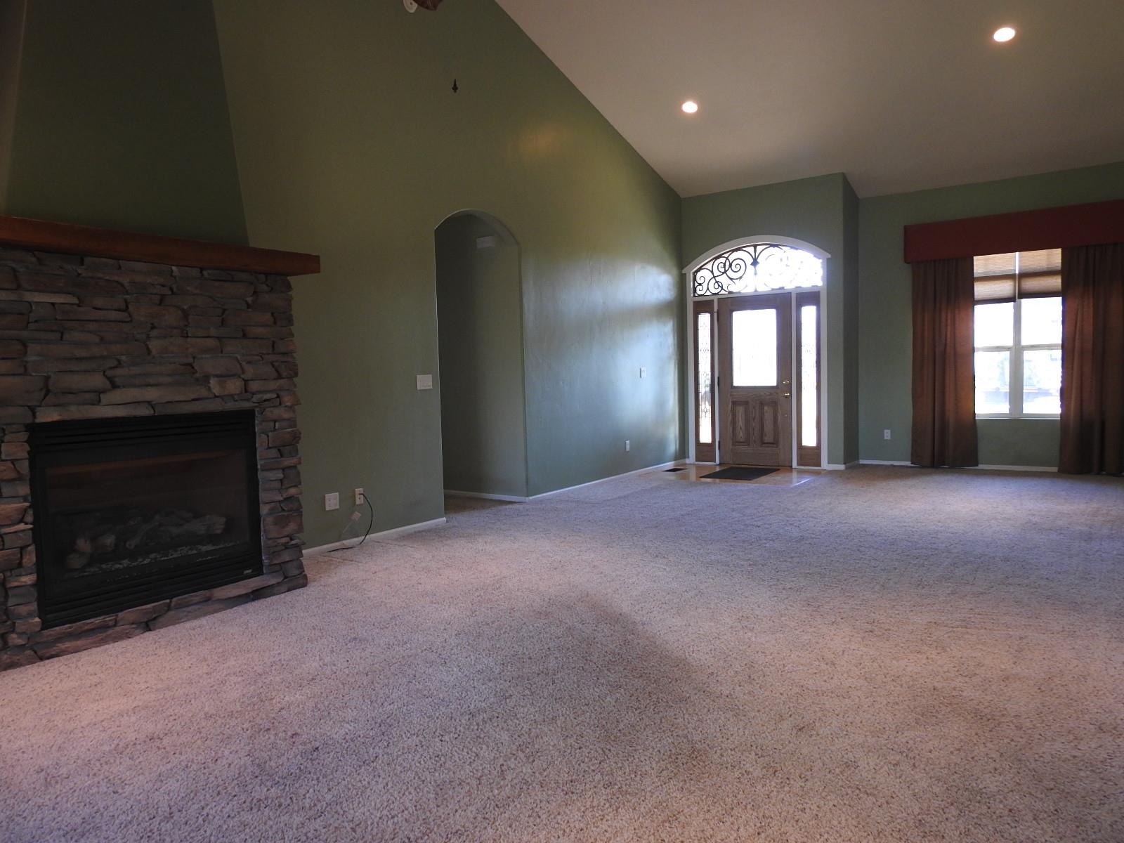 1601 Anvil View Avenue Rifle, CO 81650 - Photo 5 of 35 an empty room with windows and fireplace