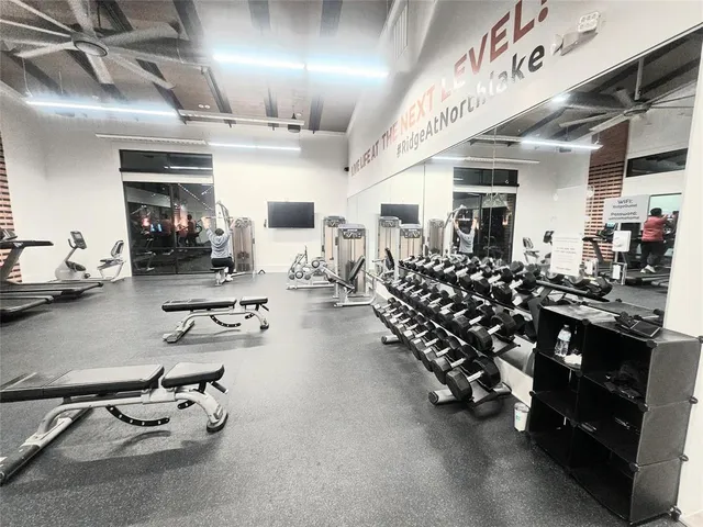 a room with gym equipment and mirrors