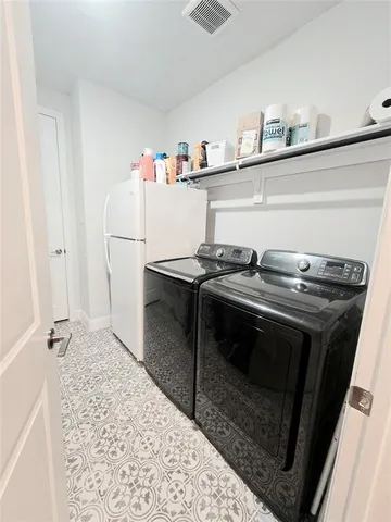 a living room with a couch and a chandelier