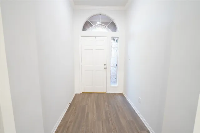 a view of a livingroom with wooden floor and a fireplace