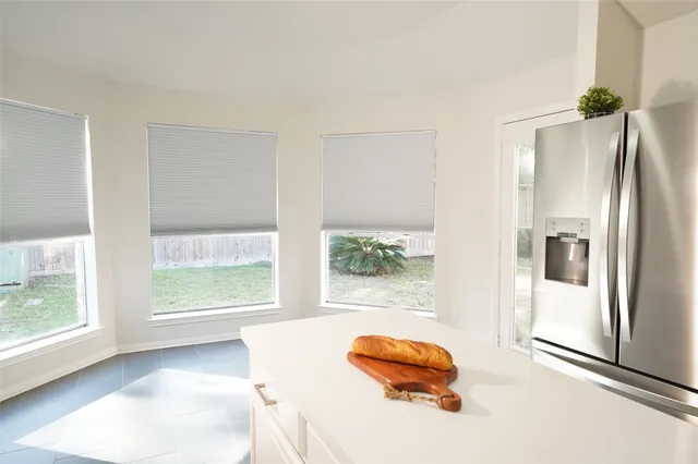a kitchen with a sink a stove top oven and white stainless steel appliances