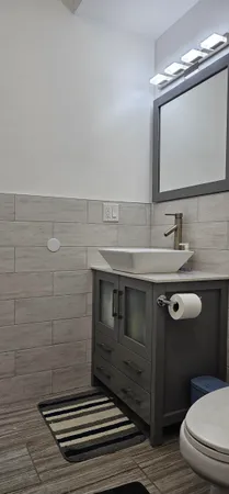 a bathroom with a sink a toilet a mirror and vanity