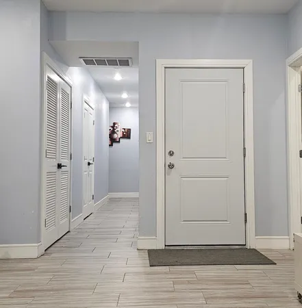 a view of a hallway with wooden floor
