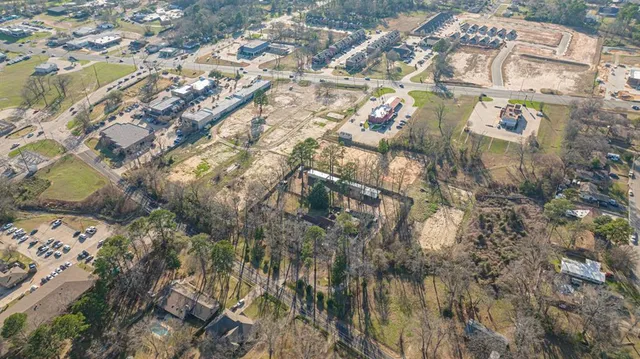 a view of a field with trees in the background