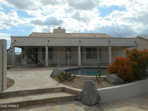 a view of a house with backyard and sitting area