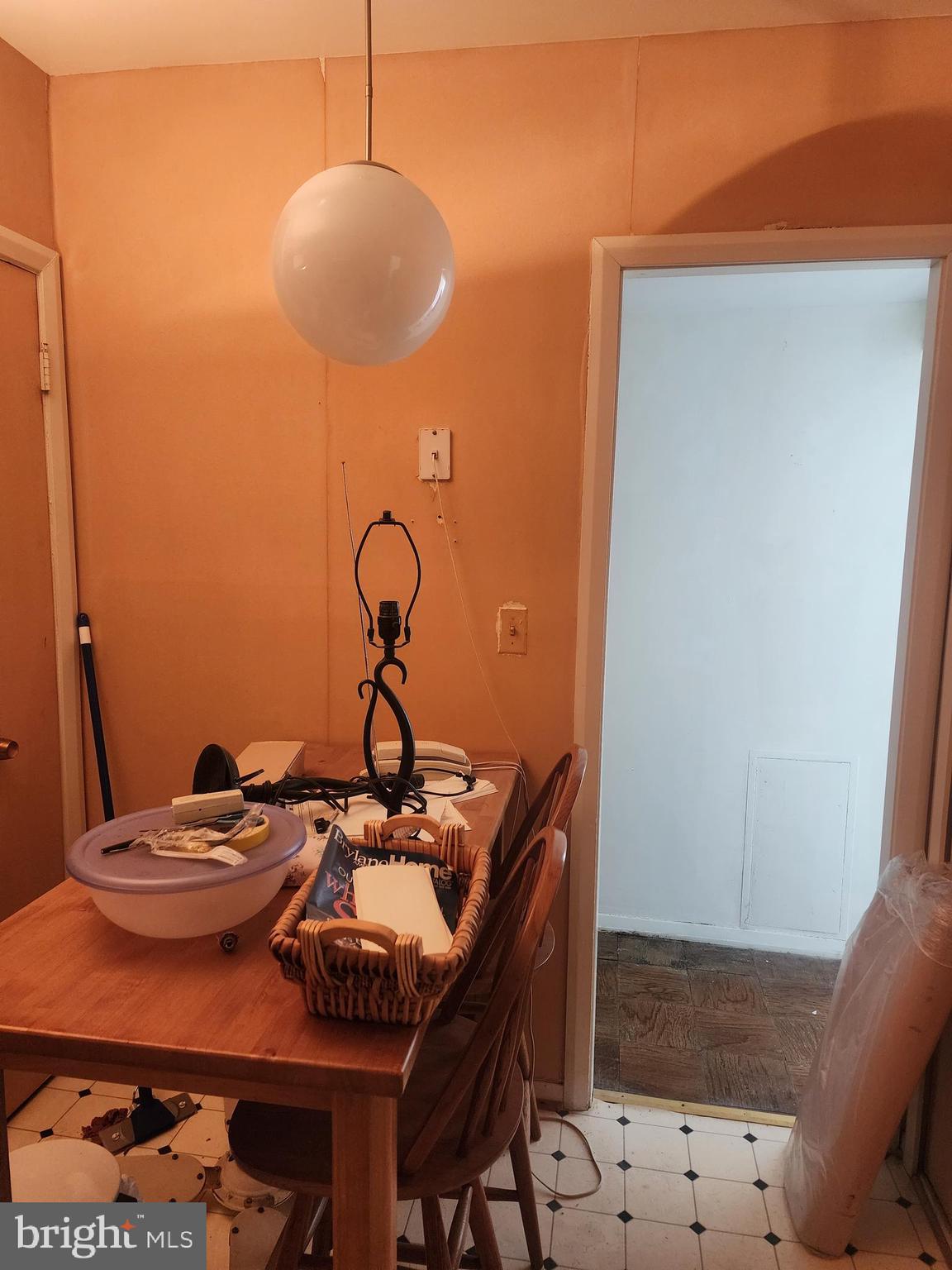 3601 Clarks Lane, Unit 416 Baltimore, MD 21215 - Photo 16 of 68 a table and chairs in a room