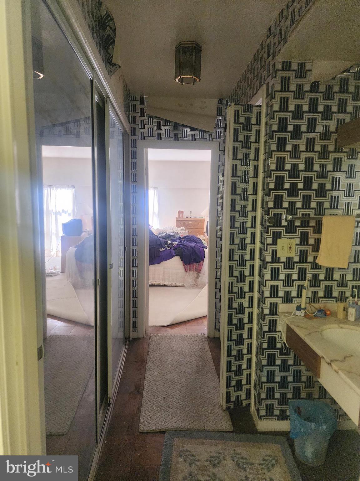 3601 Clarks Lane, Unit 416 Baltimore, MD 21215 - Photo 45 of 68 a bathroom with a sink and a mirror