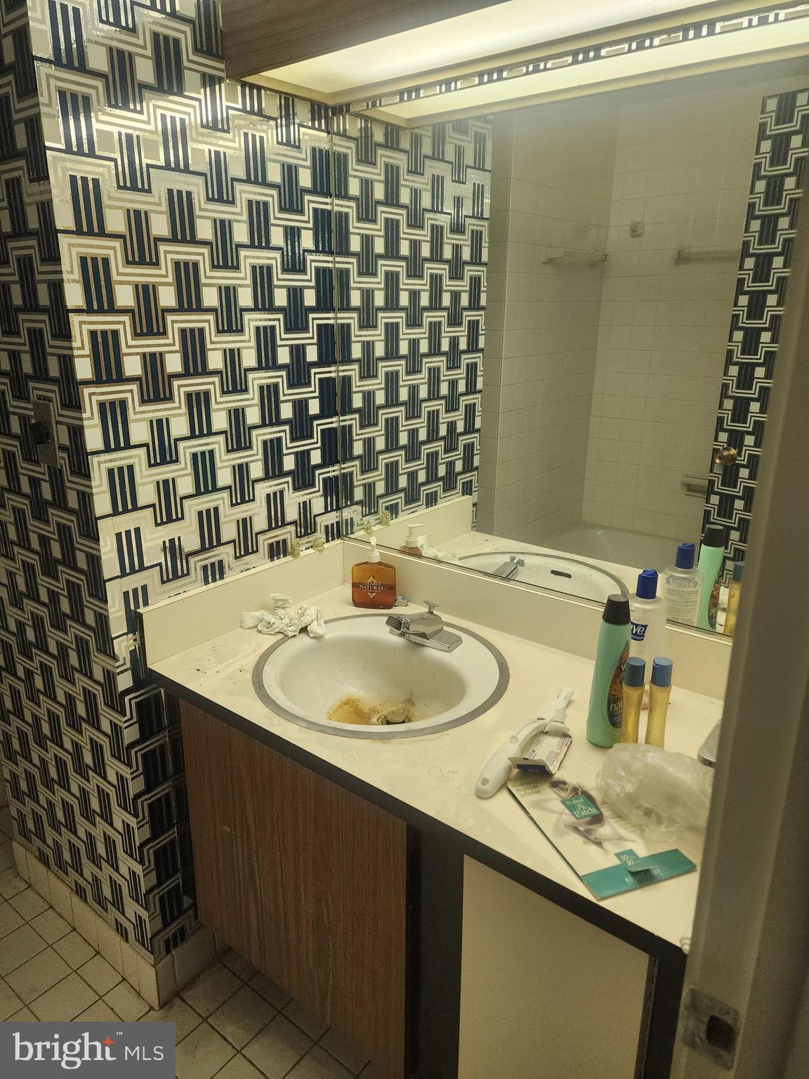 3601 Clarks Lane, Unit 416 Baltimore, MD 21215 - Photo 48 of 68 a bathroom with a sink and a mirror