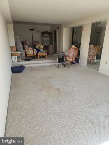 a view of a room with furniture and a window