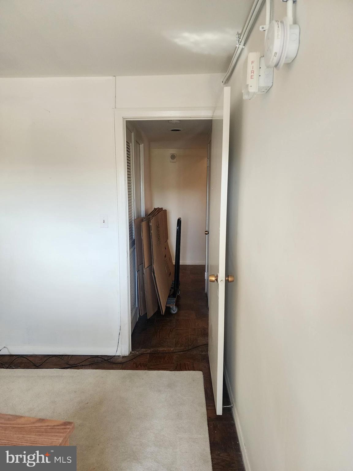 3601 Clarks Lane, Unit 416 Baltimore, MD 21215 - Photo 58 of 68 a view of a hallway with wooden floor and a potted plant