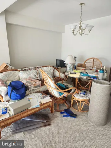 a dining room with furniture and a chandelier