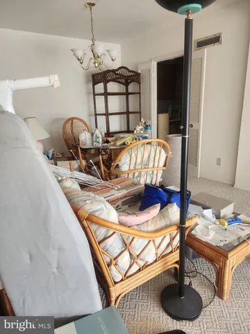 a living room with furniture a flat screen tv and floor to ceiling window