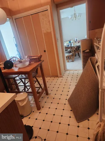 a kitchen with a sink a stove and a dining table with wooden floor