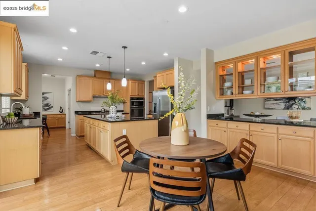 a kitchen with a dining table chairs sink and microwave