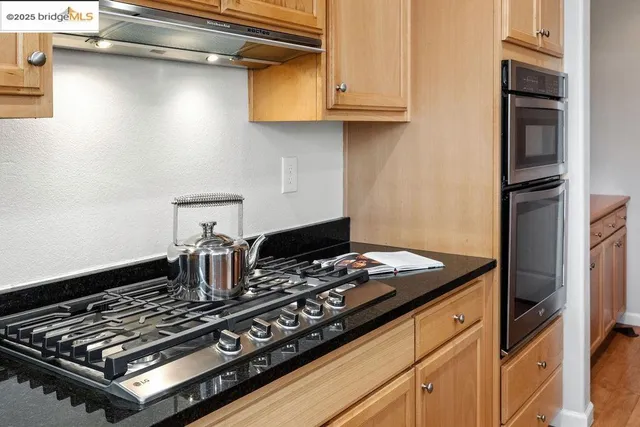 a stove top oven sitting inside of a kitchen