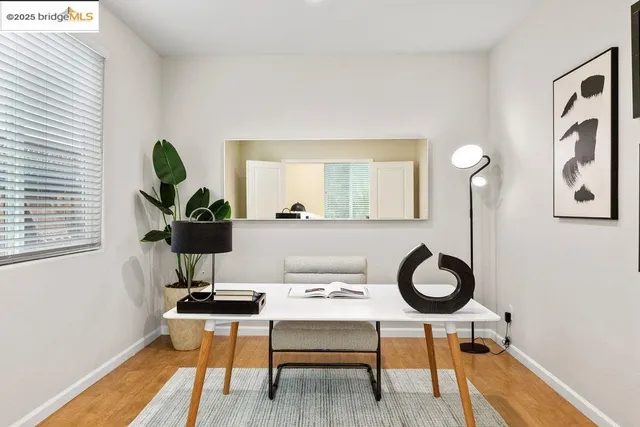 a living room with furniture a window and wall painting