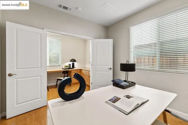 a bed sitting in a bedroom next to a window