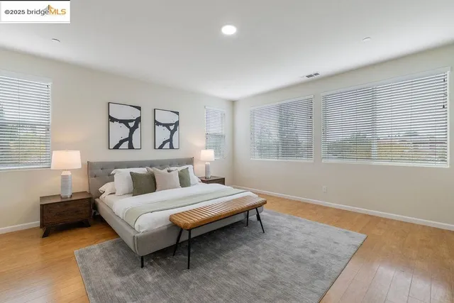 a spacious bedroom with a bed and a couch