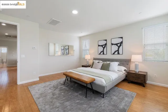 a bedroom with a bed and wooden floor