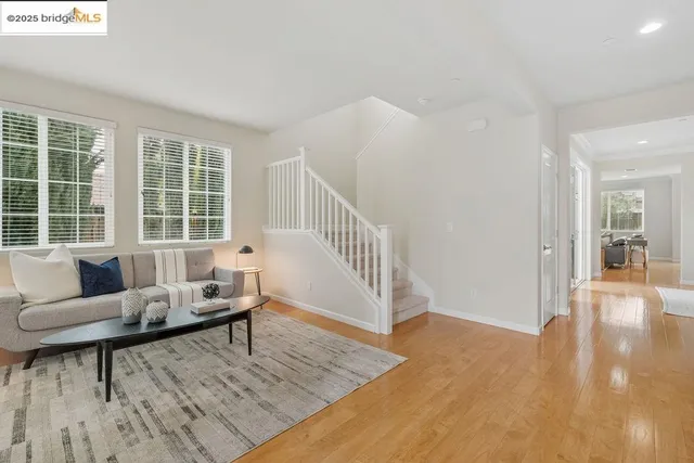 a living room with furniture and a table with wooden floor