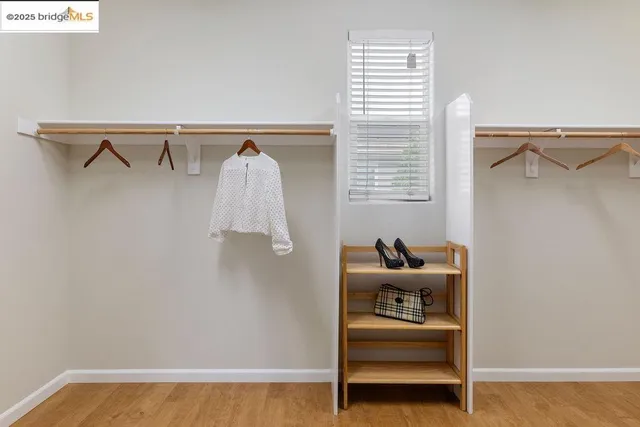 a front view of a house with a yard and potted plants