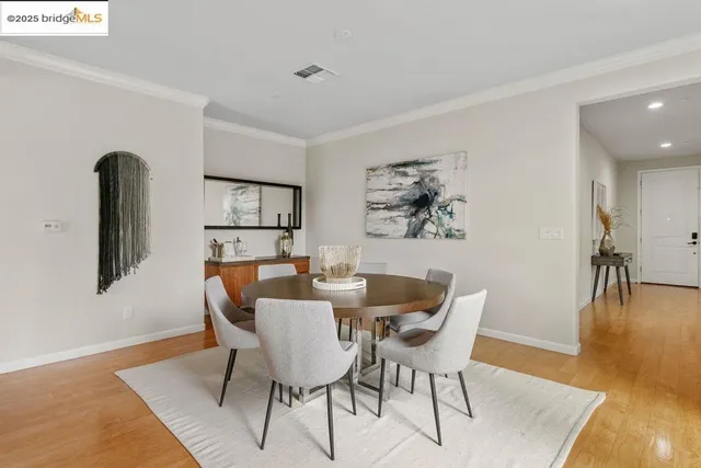 a dining room with furniture and wooden floor