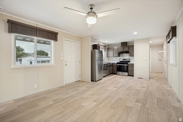 142 Cushing Way Layton, UT 84041 - Photo 4 of 15 Open-concept living area featuring light wood-finish flooring, a contemporary ceiling fan with integrated lighting, and recessed ceiling lights