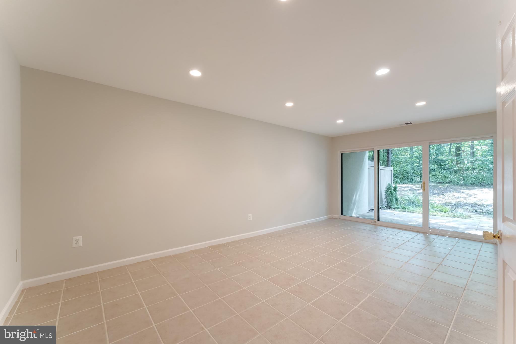 11637 Newbridge Court Reston, VA 20191 - Photo 33 of 63 a view of an empty room with wooden floor and a window