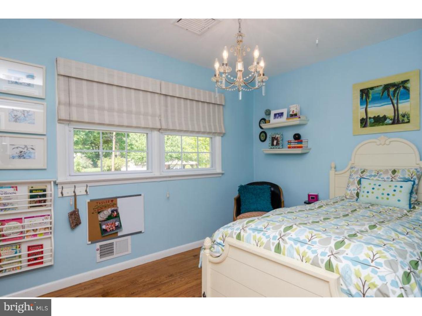 3 Griggs Road Cranbury, NJ 08512 - Photo 16 of 25 a bedroom with a bed and a chandelier