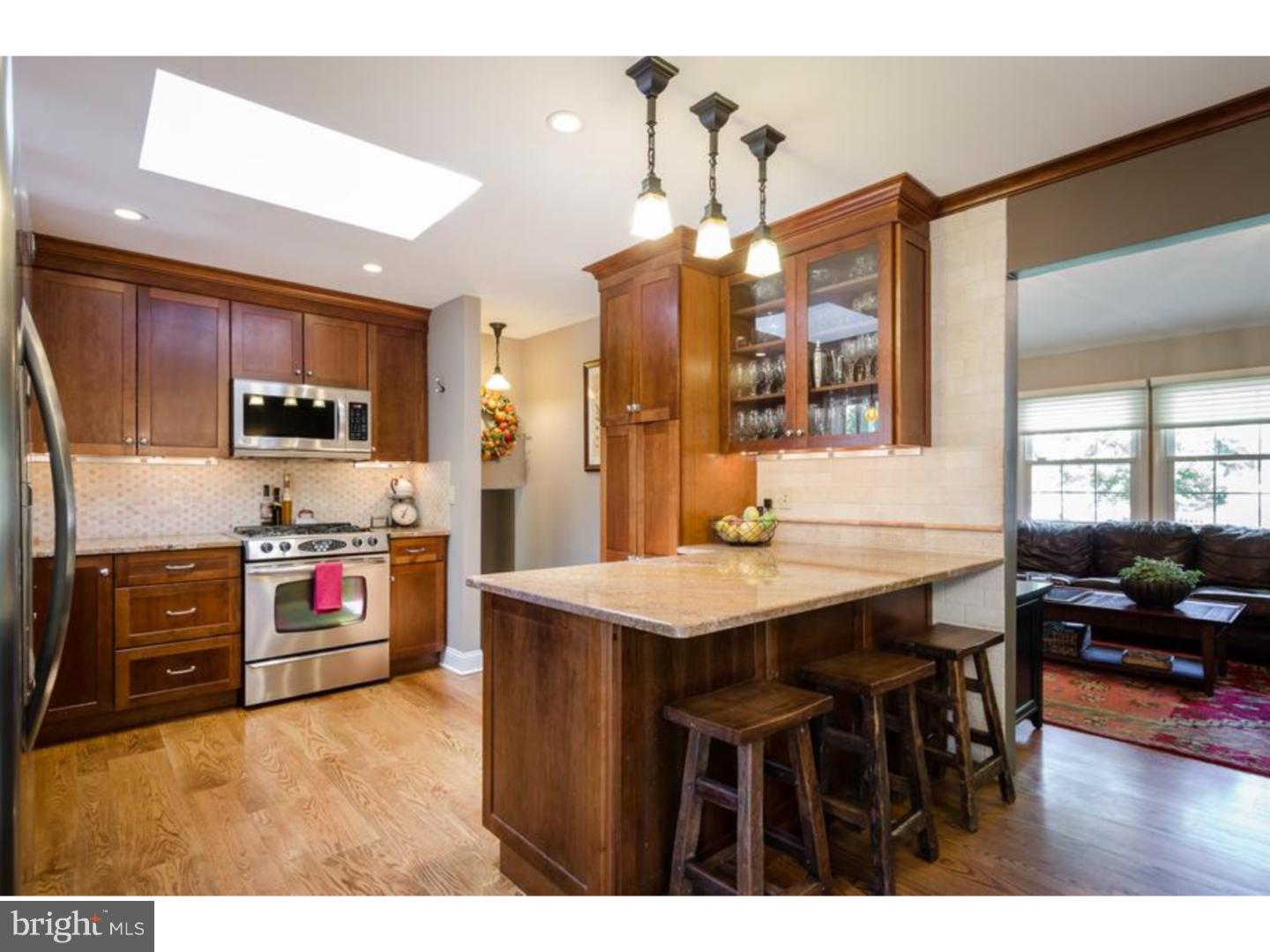 3 Griggs Road Cranbury, NJ 08512 - Photo 3 of 25 a kitchen with stainless steel appliances granite countertop a stove a refrigerator a sink dishwasher a dining table and chairs with wooden floor