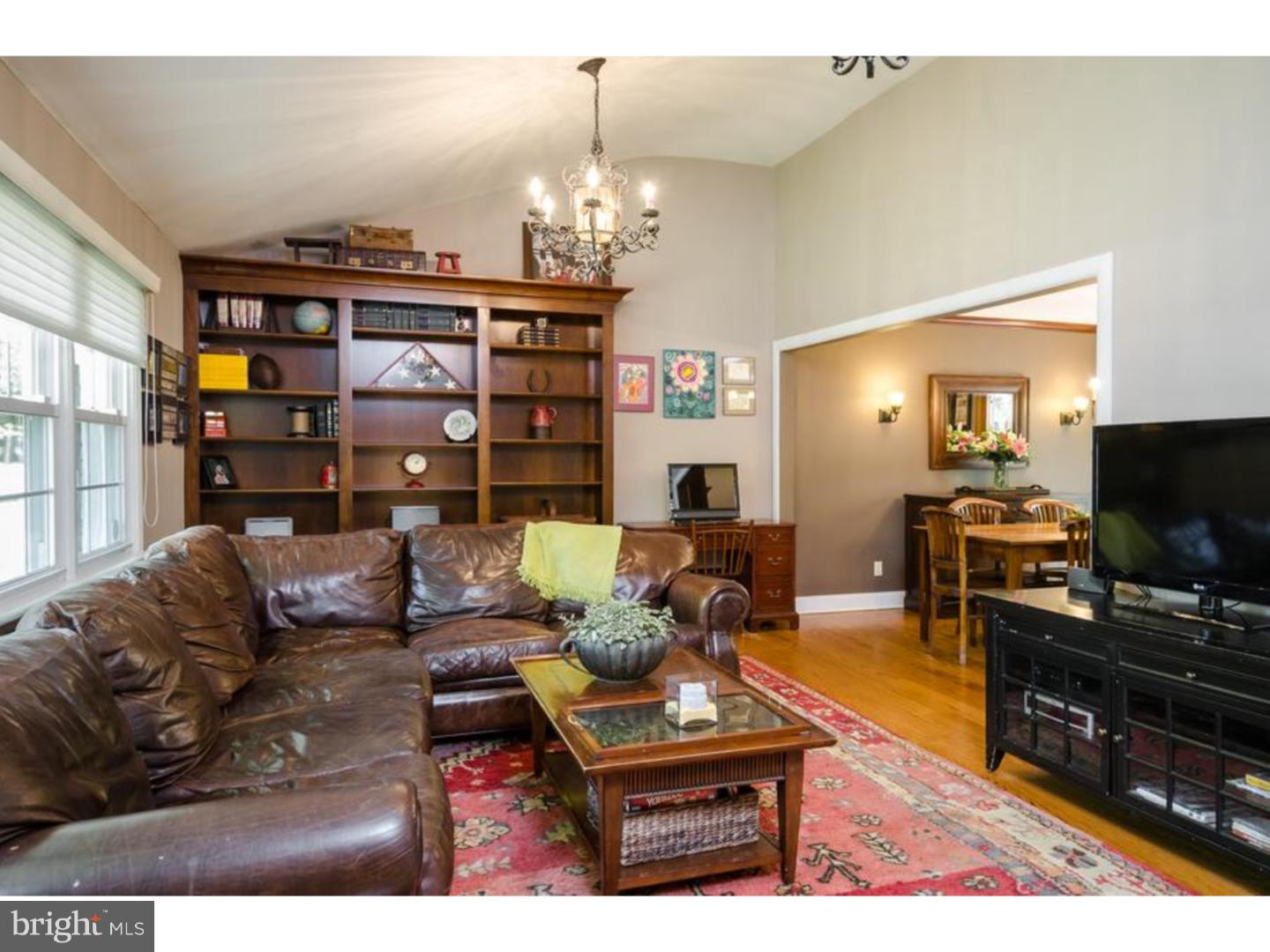 3 Griggs Road Cranbury, NJ 08512 - Photo 5 of 25 a living room with furniture a flat screen tv and chandelier