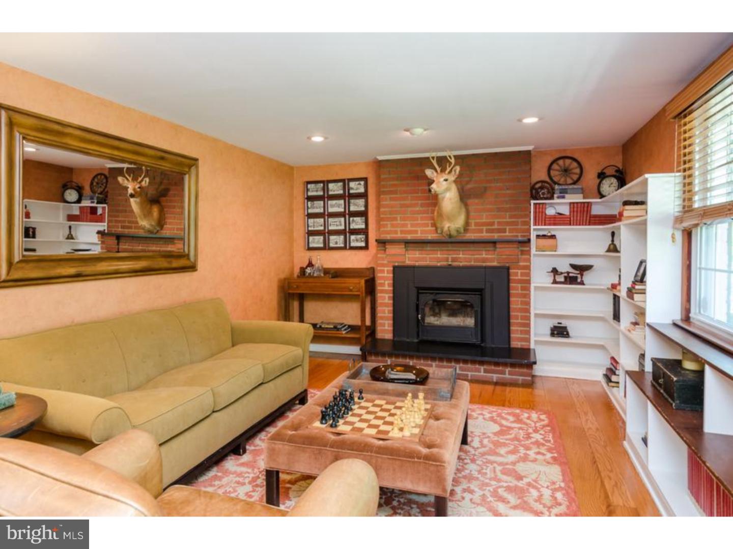 3 Griggs Road Cranbury, NJ 08512 - Photo 6 of 25 a living room with furniture a fireplace and a large window