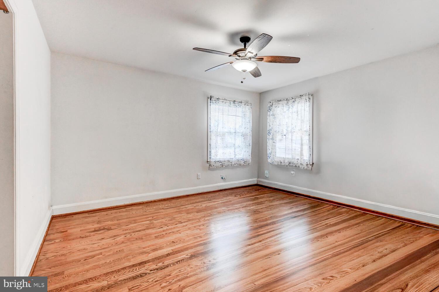 3925 Dance Mill Road Phoenix, MD 21131 - Photo 13 of 26 a view of an empty room with wooden floor and a window